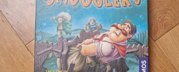 Board game box for "Smugglers," featuring colorful artwork and characters involved in the game of smuggling sweets and sour treats. Published by Kosmos, designed by Klaus and Benjamin Teuber.