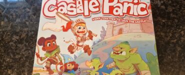 Colorful board game box for "My First Castle Panic," designed for ages 4 and up, featuring children and goblins, emphasizing teamwork in a castle defense theme. Suitable for 1-4 players, it promotes cooperative gameplay.