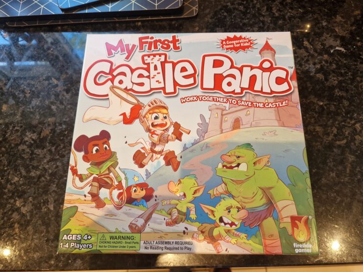 Colorful board game box for "My First Castle Panic," designed for ages 4 and up, featuring children and goblins, emphasizing teamwork in a castle defense theme. Suitable for 1-4 players, it promotes cooperative gameplay.