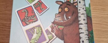Box of The Gruffalo Dominoes game by Ravensburger, featuring colorful illustrations of animals from the story. Suitable for ages 3 and up, it encourages learning and play.