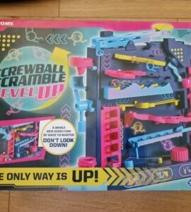 Screwball Scramble Level Up game box featuring colorful maze design, vibrant blue and pink components, and instructions highlighting the new vertical gameplay. Suitable for ages 5 and up, promoting problem-solving and coordination skills.