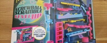 Screwball Scramble Level Up game box featuring colorful maze design, vibrant blue and pink components, and instructions highlighting the new vertical gameplay. Suitable for ages 5 and up, promoting problem-solving and coordination skills.