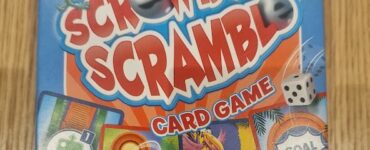 Colorful packaging of "Screwball Scramble" card game featuring playful graphics, instructions to roll dice and navigate a maze, designed for family fun and entertainment.