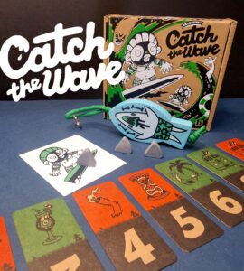 Colorful board game "Catch the Wave" featuring game components including cards, a character illustration, and game pieces, displayed with a playful design on a blue background.