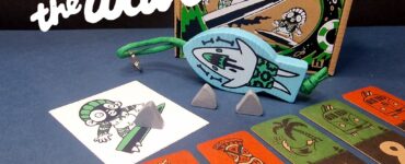 Colorful board game "Catch the Wave" featuring game components including cards, a character illustration, and game pieces, displayed with a playful design on a blue background.
