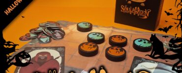 Colorful game components from the Halloween-themed board game "Soulween," featuring a spooky orange background, tokens with various designs, and the game box prominently displayed. Ideal for Halloween festivities and game nights.