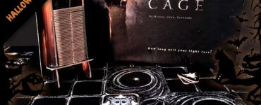Image of the board game "The Night Cage" featuring dark tiles, player pieces in red and green, and a haunting background with a hand reaching out. The image includes Halloween-themed decorations and text for a Halloween event.