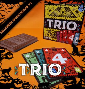 Colorful card game "Trio" displayed on an orange background, featuring a stack of cards and the game box. The cards showcase vibrant designs with numbers, perfect for family game nights. Ideal for ages 7 and up, emphasizing fun and strategy. Halloween-themed decorations enhance the festive atmosphere.