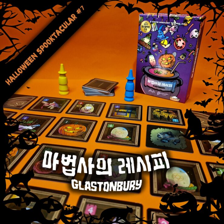 Colorful board game setup featuring "Glastonbury" with a Halloween theme, showcasing cards and game pieces on an orange background. The image includes the game box, several cards depicting spooky illustrations, and blue and yellow player tokens. Perfect for Halloween game nights.