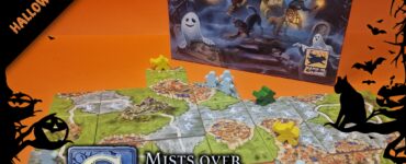Board game "Mists over Carcassonne" displayed with tiles and game pieces on an orange background, featuring ghostly characters and a fantasy landscape, perfect for Halloween-themed gaming events.
