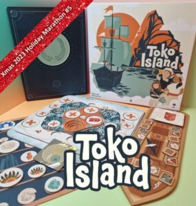 Colorful board game setup featuring "Toko Island" box art, game cards, and player boards. The image highlights components of the game and a festive banner indicating "Xmas 2023 Holiday Marathon #5." Ideal for board game enthusiasts and collectors.
