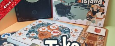 Colorful board game setup featuring "Toko Island" box art, game cards, and player boards. The image highlights components of the game and a festive banner indicating "Xmas 2023 Holiday Marathon #5." Ideal for board game enthusiasts and collectors.