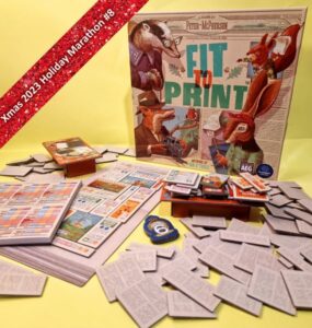 Board game "Fit to Print" by Peter McPherson displayed on a yellow background, featuring game components like cards, a score sheet, and numerous paper tiles. The game cover showcases illustrated animal characters, highlighting its theme and design.