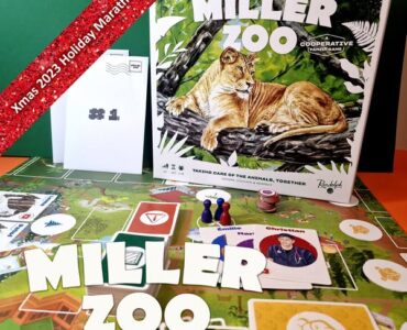 Miller Zoo cooperative board game displayed on a colorful game board, featuring a lion illustration on the box cover. The image includes game components like player tokens and character cards, along with a festive banner indicating "Xmas 2023 Holiday Marathon #4."