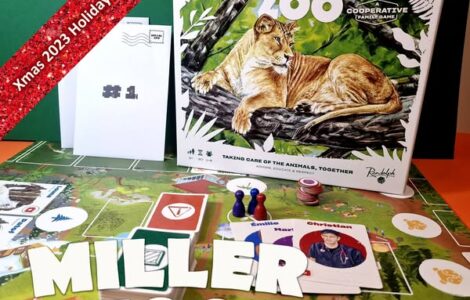 Miller Zoo cooperative board game displayed on a colorful game board, featuring a lion illustration on the box cover. The image includes game components like player tokens and character cards, along with a festive banner indicating "Xmas 2023 Holiday Marathon #4."