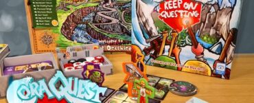 Cora Quest: Keep On Questing expansion game displayed on a wooden table, featuring game board, character tokens, and various game components, highlighting colorful artwork and gameplay elements suitable for family fun.