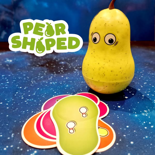 Colorful pear-shaped toy with googly eyes next to vibrant game cards on a starry background, showcasing the playful design of the "Pear Shaped" game.
