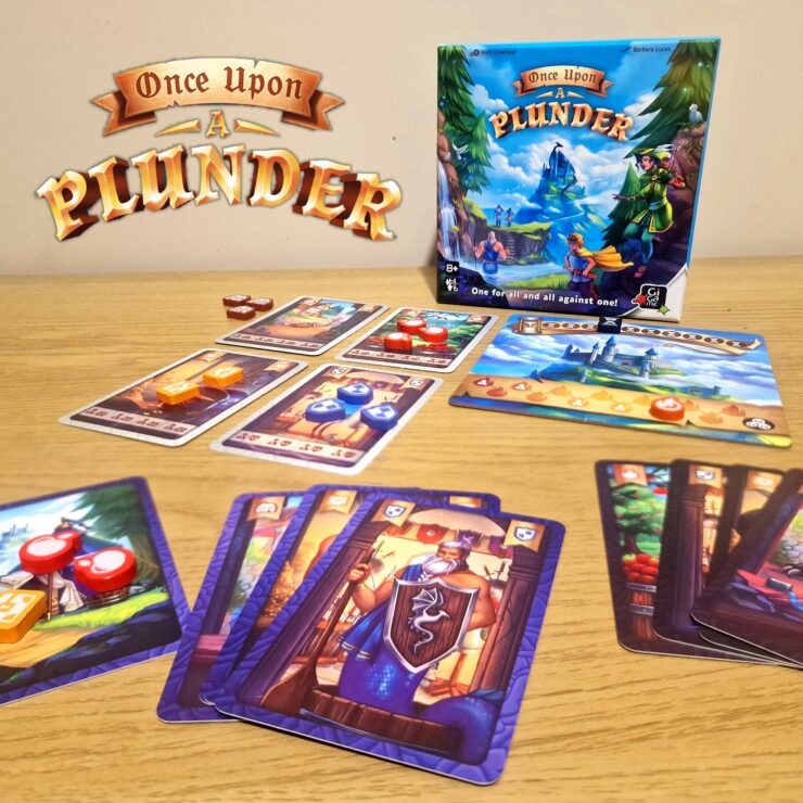 Board game "Once Upon a Plunder" displayed on a wooden table, featuring the game box, character cards, and colorful game tokens. The image showcases gameplay elements, including cards with various illustrations and point values, emphasizing the cooperative and competitive nature of the game.