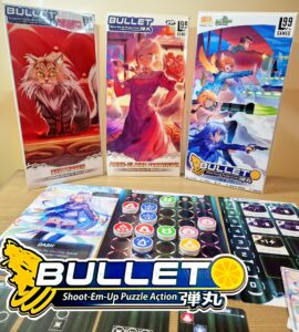 Image of the board game "BULLET," featuring three expansion packs: "Beethoven," "Anne-Claire Fortin," and "Orange Juice." The game includes colorful character cards and a unique game board with various action and puzzle elements, highlighting its shoot-em-up gameplay. The logo prominently displays the game's title and tagline.