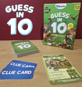 Colorful image of the "Guess in 10: Deadly Dinosaurs" game by Skillmatics, featuring the game box, clue cards, and a Stegosaurus information card. Ideal for family game nights, suitable for 2-6 players aged 8 to 99.