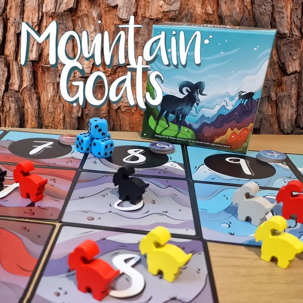 Colorful game pieces and dice are displayed on a board for the game "Mountain Goats," featuring a vibrant cover illustration of a goat on a mountain landscape.