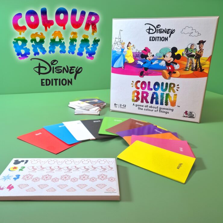 Colour Brain Disney Edition board game displayed on a green background, featuring colorful question cards, answer cards, and a game box with iconic Disney characters. Suitable for 2 to 12 players aged 8 and up, this game challenges players to guess the colors of various Disney-themed items.