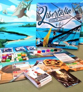 Image of the board game "Libertalia: Winds of Galecrest," featuring the game box, game cards, and various player tokens on a colorful game board. The background showcases a vibrant seascape with ships and islands, emphasizing the maritime theme of the game.