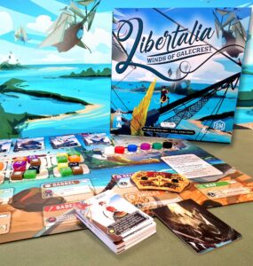 Image of the board game "Libertalia: Winds of Galecrest," featuring the game box, game cards, and various player tokens on a colorful game board. The background showcases a vibrant seascape with ships and islands, emphasizing the maritime theme of the game.