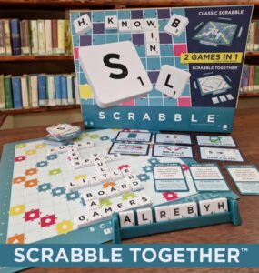 Scrabble Together game box displayed with game pieces and board, featuring colorful tiles, goal cards, and letters, set against a library background. Perfect for family game nights and word enthusiasts.