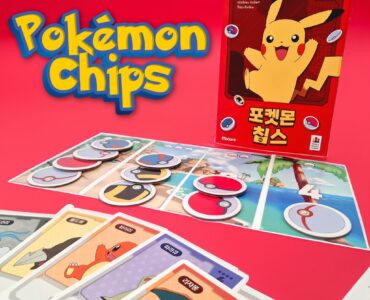 Colorful display of Pokémon Chips game featuring Pikachu on the box, with game pieces and character cards laid out on a vibrant pink background. Ideal for Pokémon fans and collectors, showcasing interactive gameplay elements.