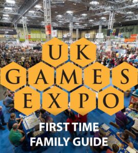 Aerial view of the UK Games Expo showcasing a bustling crowd of attendees engaging with tabletop games and vendors, featuring the event's logo and a "First Time Family Guide" text overlay.