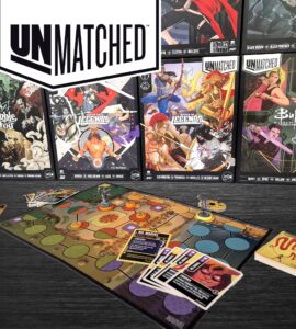 Unmatched board game setup featuring a colorful game board, character figures, and action cards, with various expansion sets displayed in the background, including characters from Marvel and Buffy the Vampire Slayer.