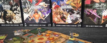 Unmatched board game setup featuring a colorful game board, character figures, and action cards, with various expansion sets displayed in the background, including characters from Marvel and Buffy the Vampire Slayer.