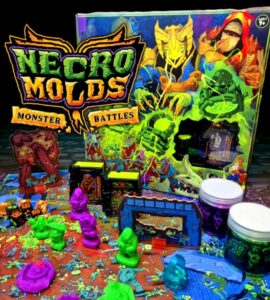 Colorful tabletop game setup of Necro Molds: Monster Battles featuring vibrant monster figures, game pieces, and the eye-catching game box in the background, designed for strategic gameplay and creativity.