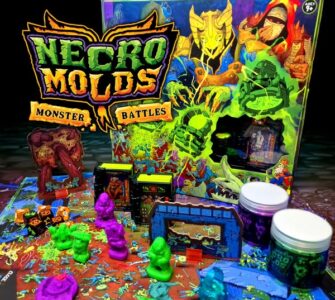 Colorful tabletop game setup of Necro Molds: Monster Battles featuring vibrant monster figures, game pieces, and the eye-catching game box in the background, designed for strategic gameplay and creativity.