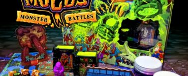 Colorful tabletop game setup of Necro Molds: Monster Battles featuring vibrant monster figures, game pieces, and the eye-catching game box in the background, designed for strategic gameplay and creativity.