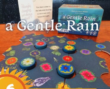 Board game "A Gentle Rain" by Kevin Wilson displayed with game pieces and a promotional card, featuring vibrant floral designs on a puzzle-like game board. The image highlights the game's relaxing theme, suitable for ages 8 and up, and is part of the Summer Marathon 2024 event.