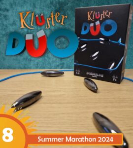 KluSter Duo board game displayed on a wooden table, featuring a colorful box with game pieces and a blue cord, promoting the Summer Marathon 2024 event. Ideal for 1-2 players aged 7 and up, highlighting its engaging gameplay.