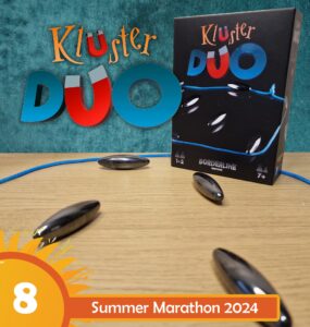 KluSter Duo board game displayed on a wooden table, featuring a colorful box with game pieces and a blue cord, promoting the Summer Marathon 2024 event. Ideal for 1-2 players aged 7 and up, highlighting its engaging gameplay.