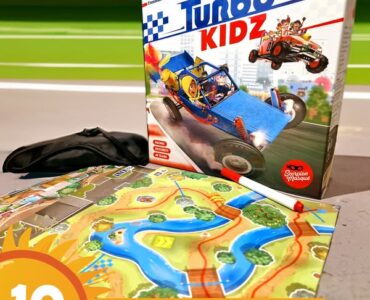 Box of the board game "Turbo Kidz" featuring colorful artwork of racing cars, placed next to a game map with rivers and landscapes, alongside a black item, promoting the Summer Marathon 2024 event.