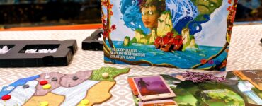 Board game "Spirit Island" displayed on a table, featuring its colorful box art, game board with various tokens, and character cards, promoting a cooperative strategy experience. Text overlay indicates "Summer Marathon 2024" event.
