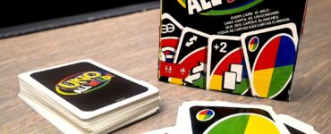 Colorful UNO All Wild! card game box displayed next to a stack of cards, featuring vibrant graphics and the text "Every card is wild." Promoting the Summer Marathon 2024 event with a playful design.