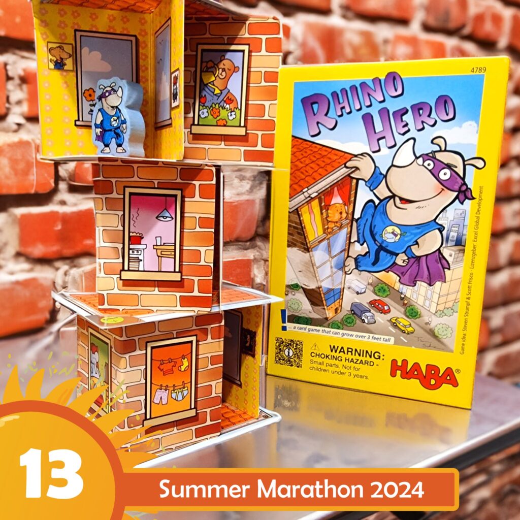 Colorful display of the "Rhino Hero" card game by HABA, featuring a stacked tower of cardboard rooms with playful illustrations, set against a brick background. The image promotes the Summer Marathon 2024 event, showcasing the game's vibrant box and character figures.