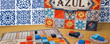 Board game "Azul" by Michael Kiesling displayed on a wooden table with colorful tiles and game components, set against a decorative blue and white background. The image promotes the Summer Marathon 2024 event.