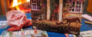 Board game "Forever Home" by Lottie and Jack Hayfell displayed on a table with colorful game pieces and cards, set against a cozy fireplace background, showcasing a warm, inviting atmosphere for game night during the Summer Marathon 2024.