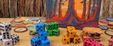 Colorful game components including dice and tokens from the board game "Sequoia" by Chad DeShon, displayed on a wooden table with a background of tree bark. The image promotes the Summer Marathon 2024 event.