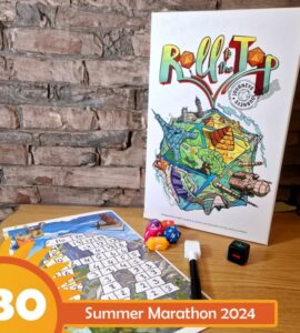 Colorful board game "Roll to the Top" displayed on a wooden table, featuring vibrant artwork and game components including dice and a score sheet, with a brick wall in the background. Ideal for family game nights and gatherings.
