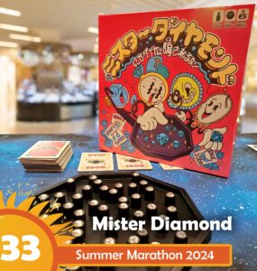 Mister Diamond board game displayed on a colorful table during Summer Marathon 2024, featuring vibrant artwork on the box, game cards, and a hexagonal game board with shiny gems.