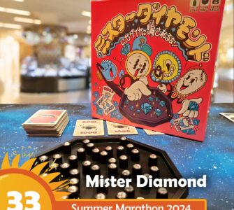 Mister Diamond board game displayed on a colorful table during Summer Marathon 2024, featuring vibrant artwork on the box, game cards, and a hexagonal game board with shiny gems.