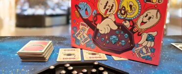 Mister Diamond board game displayed on a colorful table during Summer Marathon 2024, featuring vibrant artwork on the box, game cards, and a hexagonal game board with shiny gems.